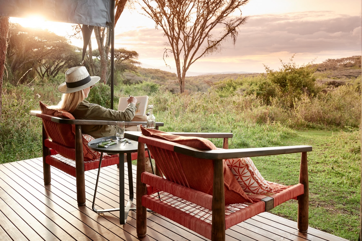 Sanctuary-Ngorongoro-Crater-Camp-Tanzania Woman sitting on her private deck